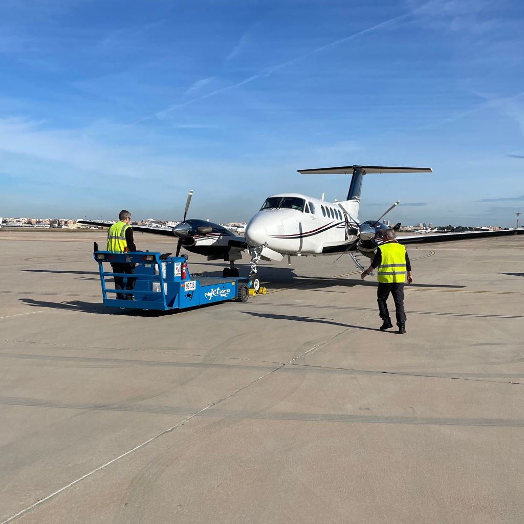 Alpine Wings King Air B200GT parked on the airport apron.