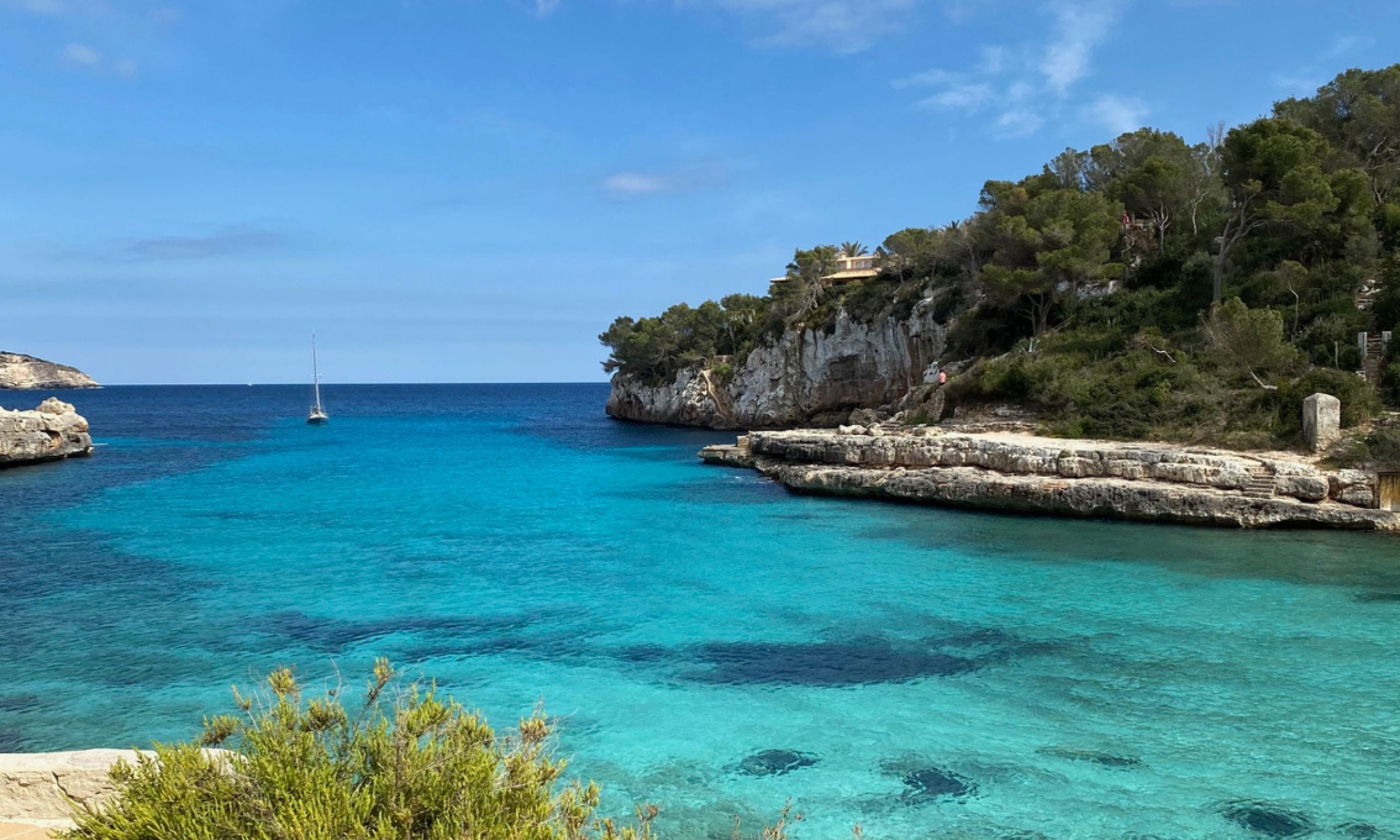 Turquoise bay surrounded by cliffs in Mallorca, Spain.